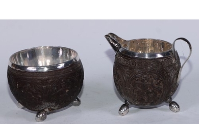 A 19th century Colonial silver mounted coconut jug and bowl,...