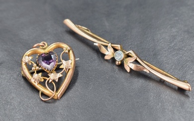 A 9ct gold openwork heart shaped brooch, having a central heart shaped amethyst surrounded by a vine