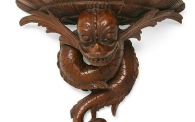 A Baroque style dolphin form wall bracket