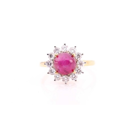 A Burmese ruby and diamond cluster ring set with a cabochon ...