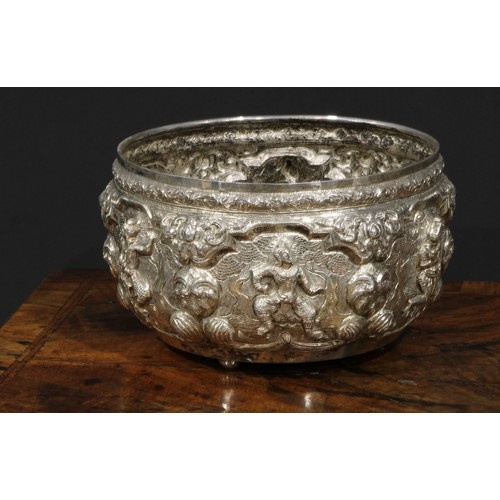 A Burmese silver circular bowl, repousse chased with figures...