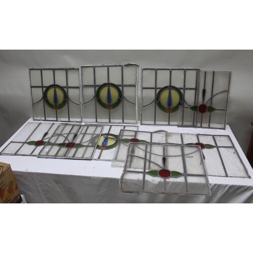 A COLLECTION OF TEN LEADED LIGHT WINDOW PANELS, central colo...