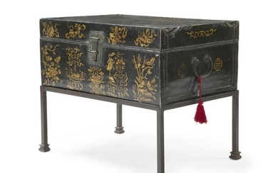 A Chinese black lacquered leather trunk on stand