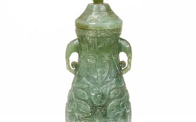A Chinese jade archaistic twin-handled pear-shaped bottle vase and cover Qing dynasty,...