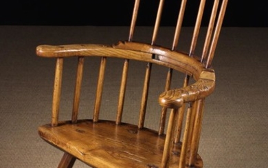 A Fine 18th Century Primitive Welsh Ash Comb-back Windsor Armchair. The slightly curved top rail abo