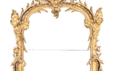 A French Regence style carved giltwood mirror. Mid-19th century. H. 130 cm....