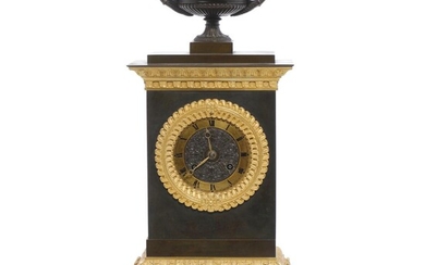 A French late Empire gilt ans patinated bronze mantel clock adoened with...