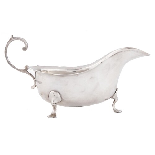 A George V silver sauceboat, with flying scroll handle, 18cm...