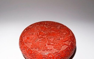 A LARGE CHINESE CINNABAR LACQUER CIRCULAR 'DRAGON' BOX AND COVER...