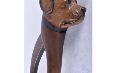 A PAIR OF 19TH CENTURY BAVARIAN BLACK FOREST CARVED WOOD DOG...