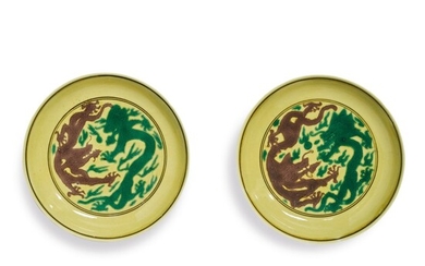 A PAIR OF GREEN AND AUBERGINE-ENAMELED YELLOW-GROUND 'DRAGON' DISHES, KANGXI MARKS AND PERIOD