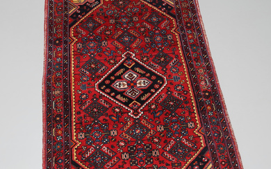 A Persian rug, hand-knotted, 218 x 136 cm.