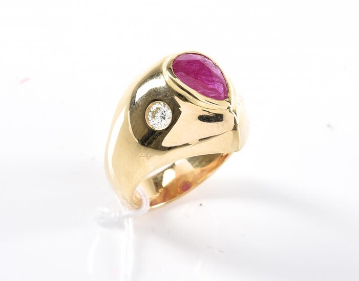 A RUBY AND DIAMOND SIGNET RING - Centrally collette set with a pear cut ruby weighing 1.25cts, flanked by hammer set round brilliant...