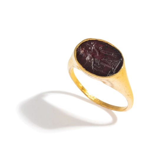 A Roman Gold and Garnet Finger Ring with the Goddess Fortuna Thyche.