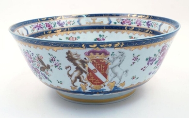A Samson punch bowl, 19th century, decorated in Chinese export style with floral sprays and gilt highlighted cobalt blue double border to the inside rim and exterior foot, with armorial crest to the exterior, iron red mark to the underside, 28cm...