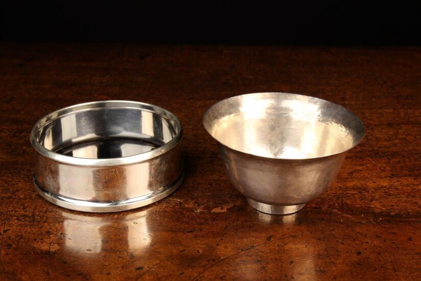 A Swedish Sterling Silver Wine Coaster stamped BORGILA and a small hammered white metal bowl with fl