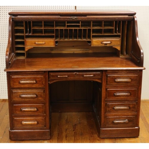 A VINTAGE OAK ROLL TOP DESK with tambour shutter containing ...