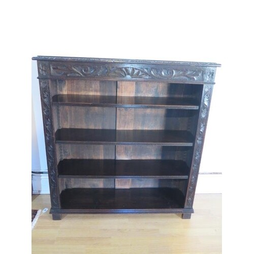 A Victorian carved oak bookcase with adjustable shelves, 115...
