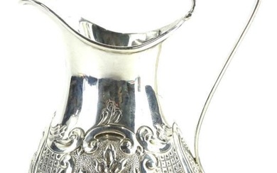 A Victorian silver baluster shaped cream jug, embossed with...