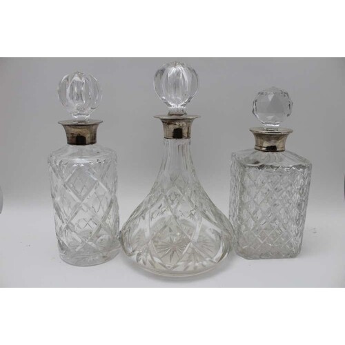 A collection of three silver collar, cut glass decanters, wi...
