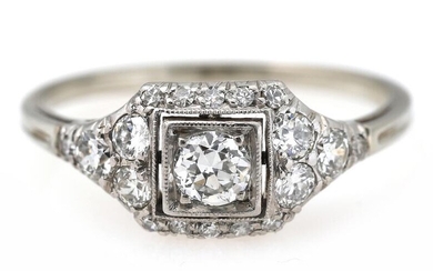 A diamond ring set with a diamond weighing app. 0.20 ct. encircled...