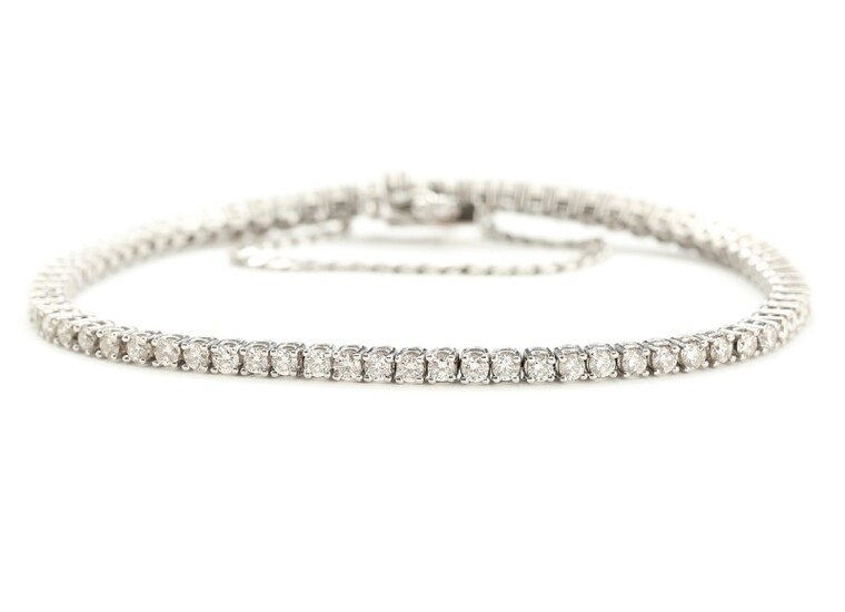 A diamond tennis bracelet set with numerous brilliant-cut diamonds totalling app. 3.27 ct., mounted in 18k white gold. L. 18.7 cm. 2006.