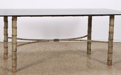 A faux bamboo metal table base with a smoked glass top circa 1950. Ht: 28.5" Wd: 78" Dpth: 40"