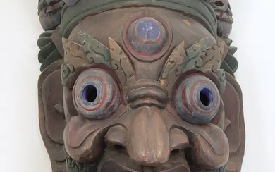 A large Tibetan Mahakala type carved and painted hardwood mask, 20th century,...
