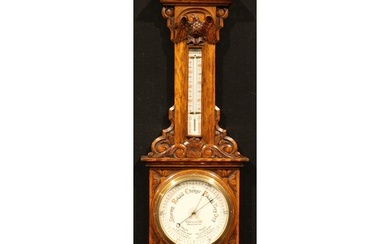 A late Victorian oak barometer, 18.5cm circular register ins...