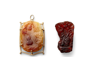 A mounted carved jade pendant and a small amber carving