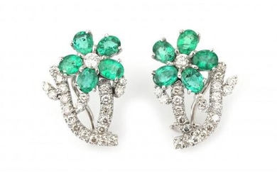 A pair of 18 karat white gold emerald and diamond earrings. Featuring oval cut emeralds and brilliant cut diamonds, ca. 1 ct. in total. Gross weight: 8 g.