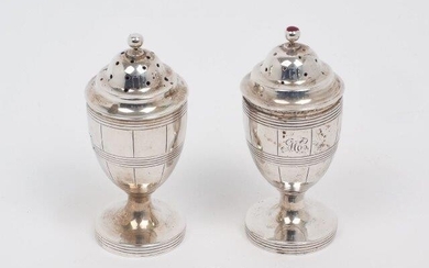 A pair of 19th Century Indian Colonial peppers, Calcutta, 1818-1829, Twentyman & Co., of ovoid vase shape, each with reeded banding and monogram to body and raised on a circular pedestal foot, the perforated, stepped domed caps with round finials...