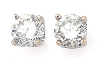 A pair of diamond ear screws each set with a brilliant-cut diamond...