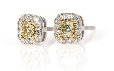 A pair of diamond ear studs each set with numerous brilliant- cut...