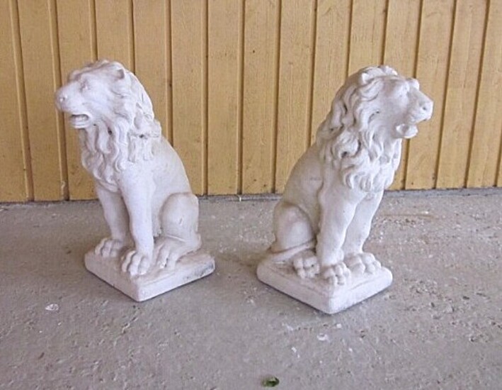 A pair of garden sculptures in the shapes of lions. Artificial stone. Late 20th century. H. 54.5 cm. W. 24 cm.