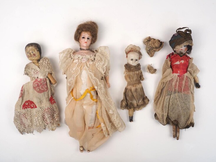 A reinforced wax lady doll, with brown mohair wig styled in a bun on cloth body with composition lower limbs, 35cm long, together with two peg wooden dolls, one a torso only, and another doll, missing finish to face, both arms and a leg, 19cm long...