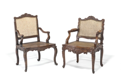 A set of two Régence carved oak armchairs with cane seats and backs, one with padded armrests. C. 1720. (2)