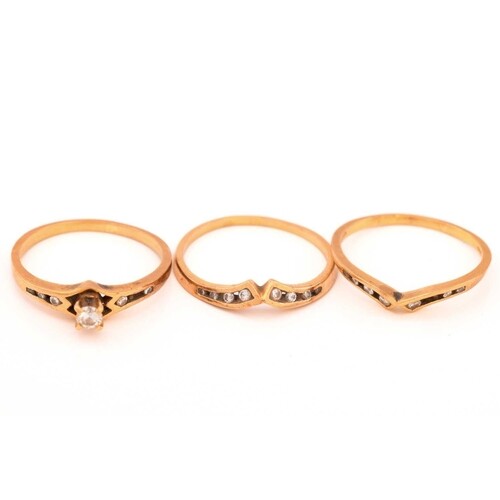 A three-piece diamond ring set in 18ct gold, consisting of a...