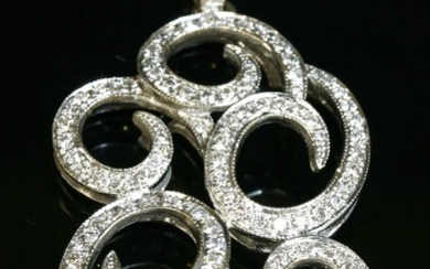 A white gold diamond set scrolling pendant