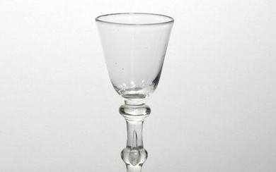 A wine glass c.1750, with a small rounded funnel bowl...