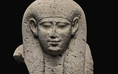 AN EGYPTIAN LIMESTONE SARCOPHAGUS MASK, 30TH DYNASTY/EARLY PTOLEMAIC PERIOD, CIRCA 250-200 B.C.