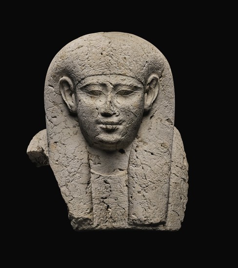 AN EGYPTIAN LIMESTONE SARCOPHAGUS MASK, 30TH DYNASTY/EARLY PTOLEMAIC PERIOD, CIRCA 250-200 B.C.
