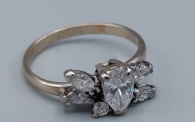An 18ct white gold ring set with a central pear shaped Diamo...