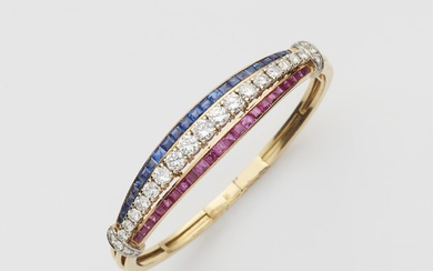 An 18k gold diamond, sapphire and ruby bangle.