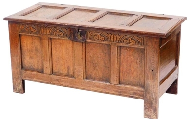 An 18thC oak four panel chest, with a carved...