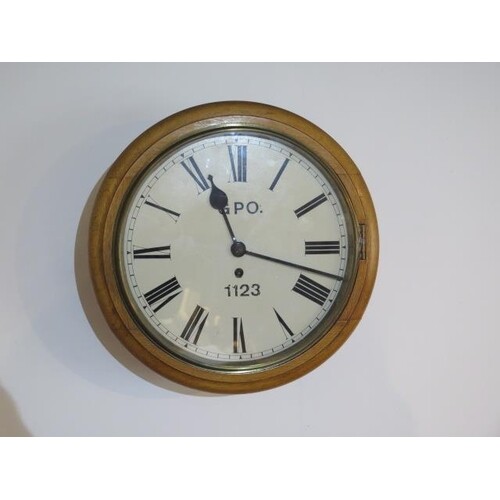 An 8 day oak case wall clock with 12" dial with fusee moveme...