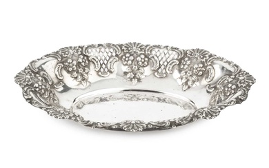 An Edwardian silver oval dish, repoussé decorated with scallops, flowers...