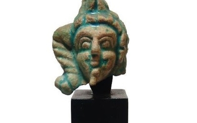 An Egyptian glazed composition head of Harpokrates