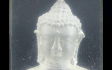 An acrylic Buddha bookend