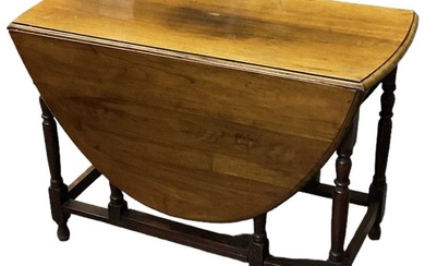 An early 20th century oak drop-leaf gateleg dining table, width...
